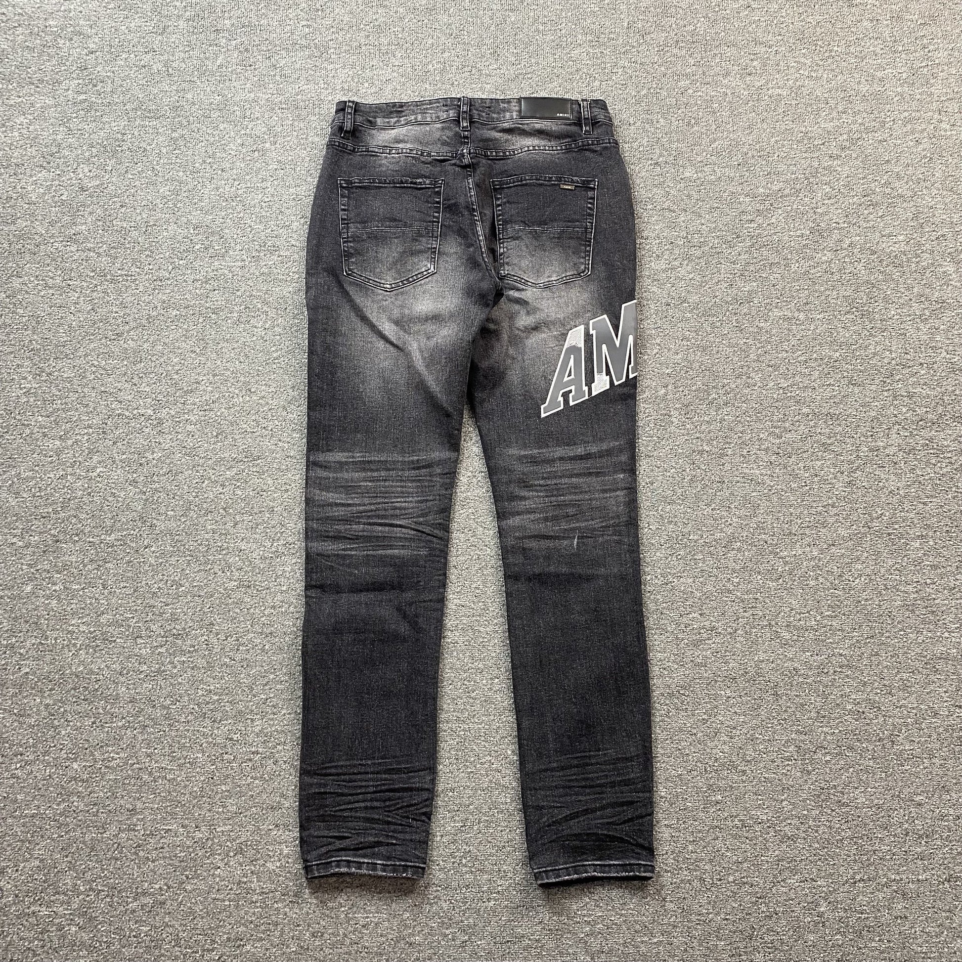 AMIRI VARSITY LOGO REPAIR JEANS
