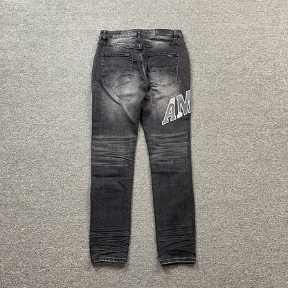 AMIRI VARSITY LOGO REPAIR JEANS