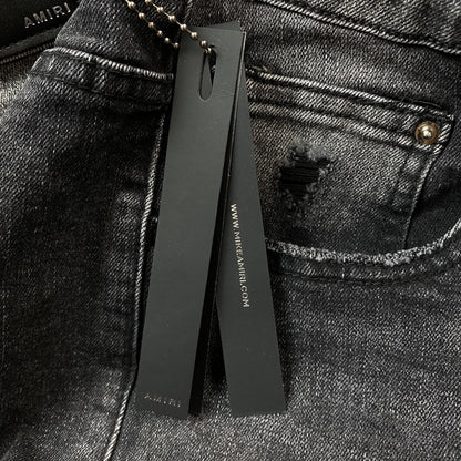 AMIRI VARSITY LOGO REPAIR JEANS